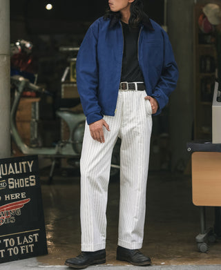 Blue cossack jacket worn over striped trousers, zip front and stand collar