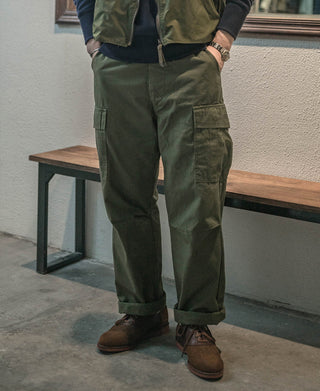 Olive cargo fatigue pants worn with brown boots, full view