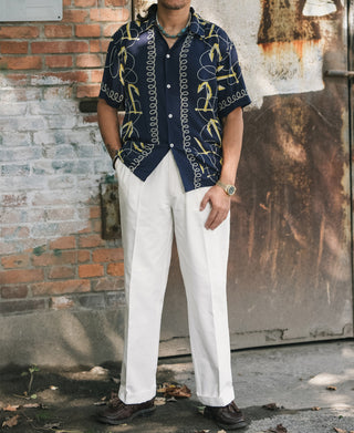 White cotton twill trousers with relaxed straight legs and front double pleats
