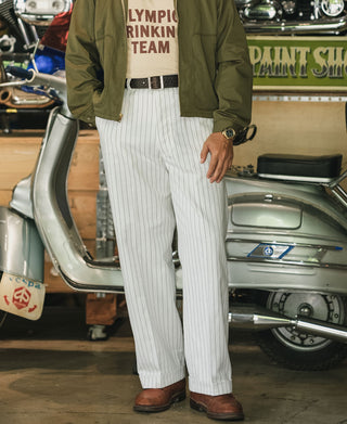 White pinstripe mechanic work pants with belt, cuffs, and brown leather shoes