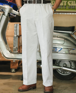 White pinstripe work pants shown full length with pleats and straight legs