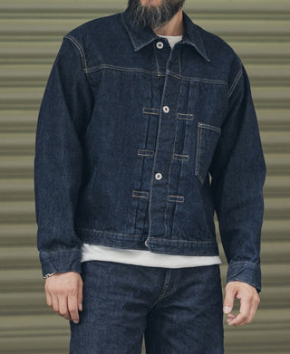 Indigo denim jacket with button front, pointed collar, and two chest pocket flaps