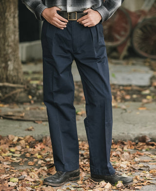 Navy cotton twill trousers, front view with double pleats, belt loops, and tapered straight leg.
