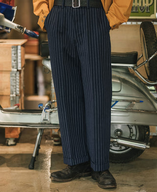Navy pinstripe work pants with straight legs and stitched hem cuffs