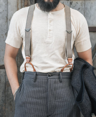 Apricot henley T-shirt with short sleeves and button placket, worn under suspenders