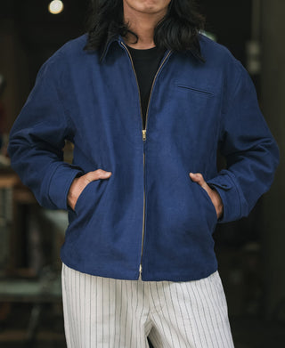 Blue cossack jacket with brass zipper, stand collar, and side pockets