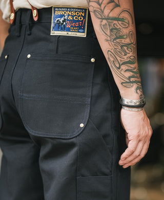 Navy canvas double knee pants with large front pocket and metal snap button details