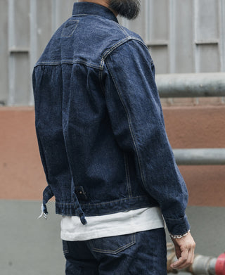 Indigo denim jacket side view with sleeve seam and pocket panel stitching