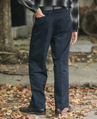 Navy cotton twill trousers, back/side view with belt loops and straight-leg silhouette.