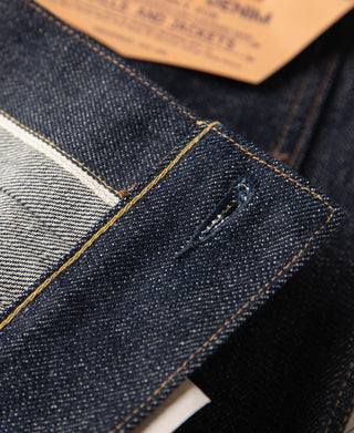 Indigo denim jacket pocket corner with yellow topstitching and rivet detail