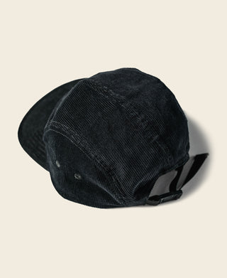 Black corduroy 5-panel cap shown from the side with adjustable strap