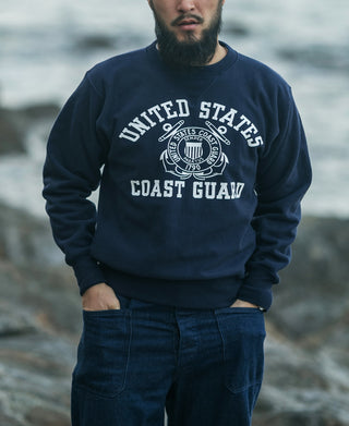 Navy crewneck sweatshirt with large Coast Guard logo graphic across the chest