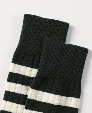 Folded dark green socks with white stripe bands