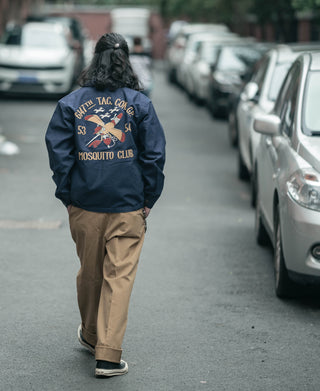 Navy tour jacket back view with large embroidered “MOSQUITO CLUB” graphic