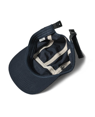 Navy 5-panel cap interior view with adjustable strap and fabric lining