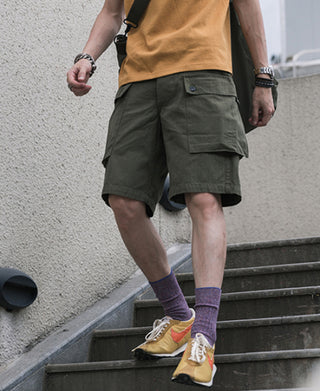 Olive cargo utility shorts worn with casual outfit, side pocket and hem detail