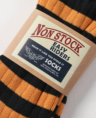 Non Stock Easy Riders socks label on orange-and-black striped knit socks.
