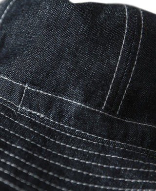 Indigo denim bucket hat close-up of crown seam and stitched band around brim