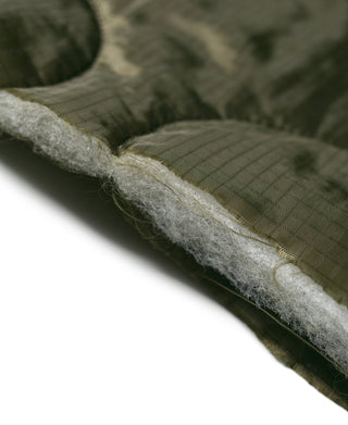 Olive padded vest seam with visible quilted lining and stitched edge detail