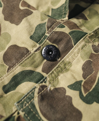 Camouflage jacket pocket flap with snap button and stitched seams