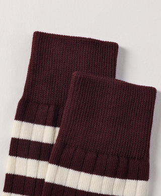 Two folded retro striped cotton socks in burgundy and white with ribbed cuffs