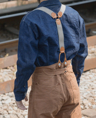 Khaki striped Y-back leather button suspenders worn over tan pants