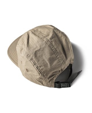 Khaki 5-panel cap with curved brim and adjustable strap on back, side angle