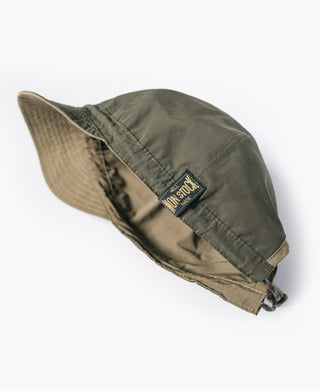 Reversible cap showing olive outer and khaki inner with logo patch