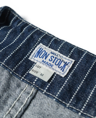 Fabric label inside an indigo striped work vest near inner seam