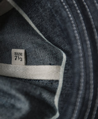 Indigo denim bucket hat inner band close-up with SIZE 7 1/2 label