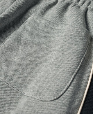 Gray cotton-terry sweatpants with elastic waistband and curved side pocket