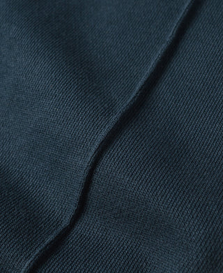 Navy cotton-terry sweatpants, close-up of textured fabric and leg seam