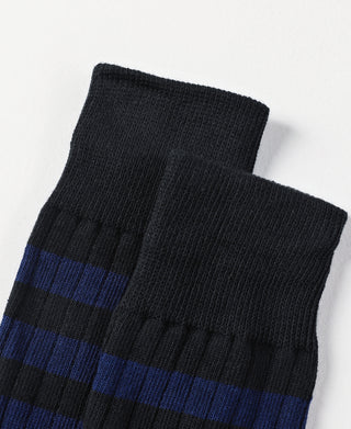 Folded black and blue striped cotton crew socks, ribbed texture