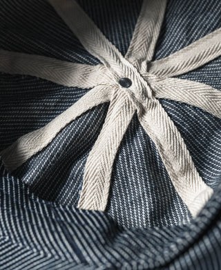 Striped denim newsboy cap with bow-like gathered crown and dark button