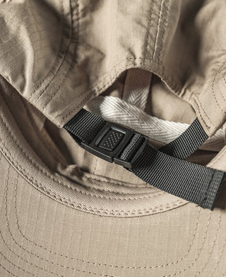 Khaki cap interior with adjustable webbing strap and plastic buckle