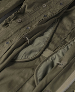 Olive M-1951 parka front pockets with buttoned flap and drawcord at waist