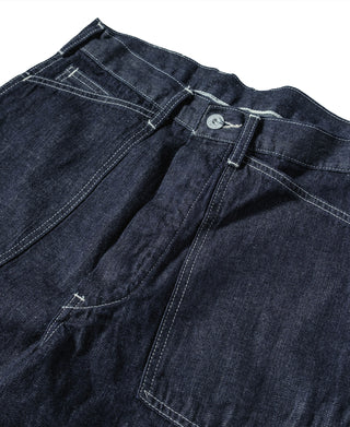 Indigo denim dungaree pants detail: button fly, top yoke seam, patch pocket