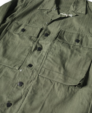 Olive green HBT jacket close-up of button front, chest pockets, and seams