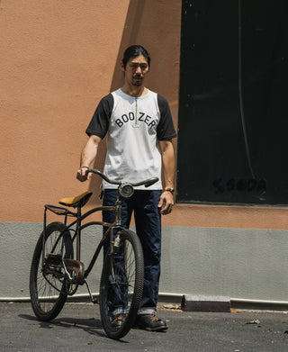 White raglan T-shirt with black sleeves and Boo Zero front graphic, quarter-zip collar