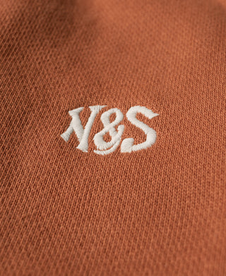 Orange cotton-terry sweatpants with white embroidered logo on front