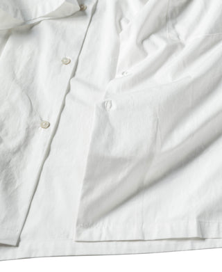 Ivory white open-collar shirt with buttoned placket and short sleeves