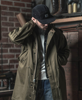 Black corduroy 5-panel cap with triangular logo patch