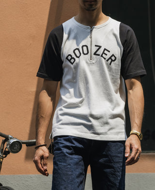 White raglan quarter-zip t-shirt with black sleeves and 'BOOZER' graphic on model