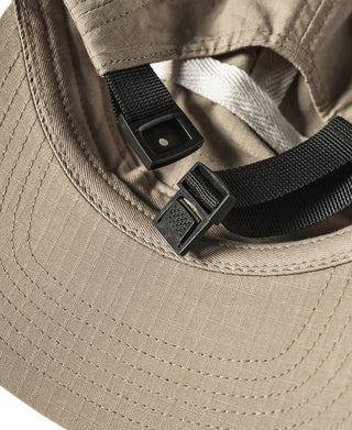 Khaki 5-panel cap with adjustable black strap and metal buckle details
