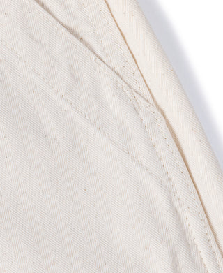 White herringbone deck pants fabric close-up with textured weave