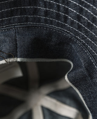 Indigo denim bucket hat interior close-up with stitched seam and inner lining
