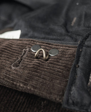 Brown corduroy work pants front with metal suspender clip and buttons
