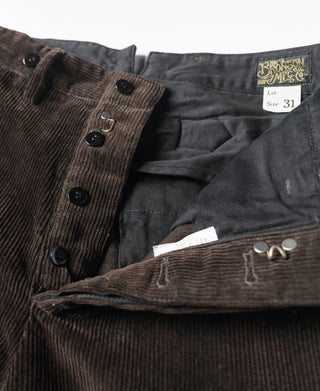 Brown corduroy pants with Bronson Mfg tag, belt loops, and front button closure