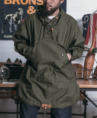 Olive cotton field parka with hood and front button placket, utility-style pockets