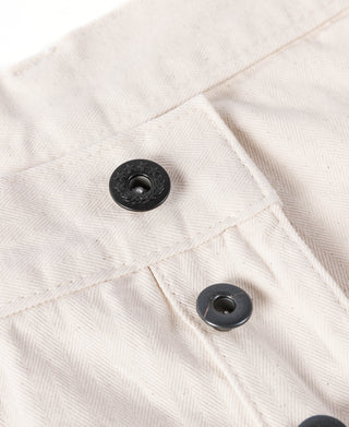 White deck pants waistband area with two black buttons and stitched seam